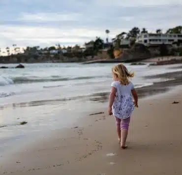 dziewczynka spacerująca wzdłuż plaży