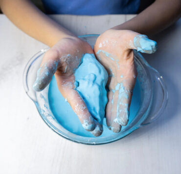 niebieska ciecz nienewtonowska w rękach dziecka